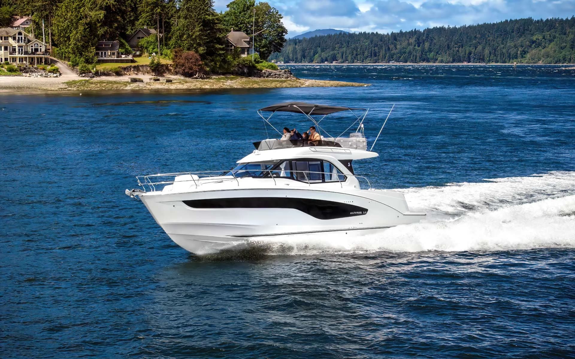 A Beneteau Antares 12 flybridge running through calm water