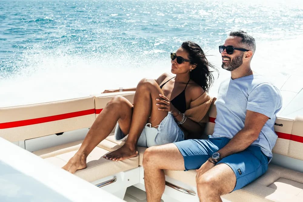 Two guests relaxing in the Wellcraft 28 cockpit