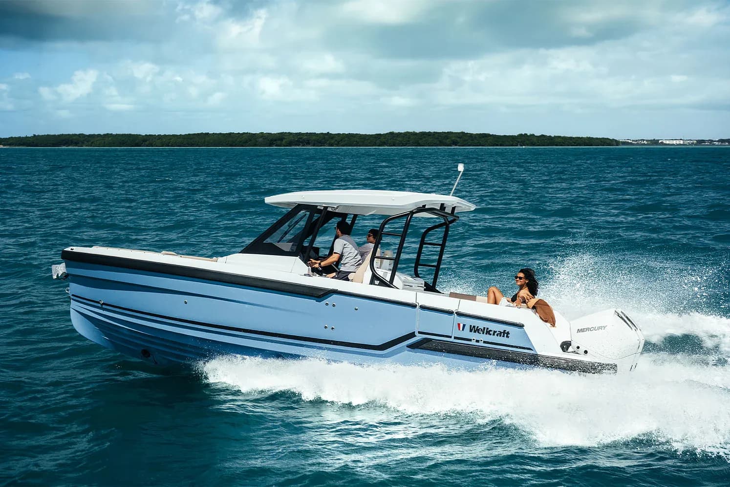 A Wellcraft 28 T-Top running at speed with two aboard