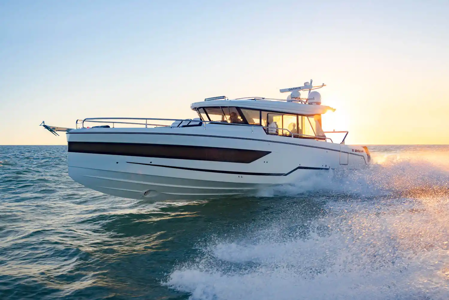 A Wellcraft 355 running at speed into a low sun