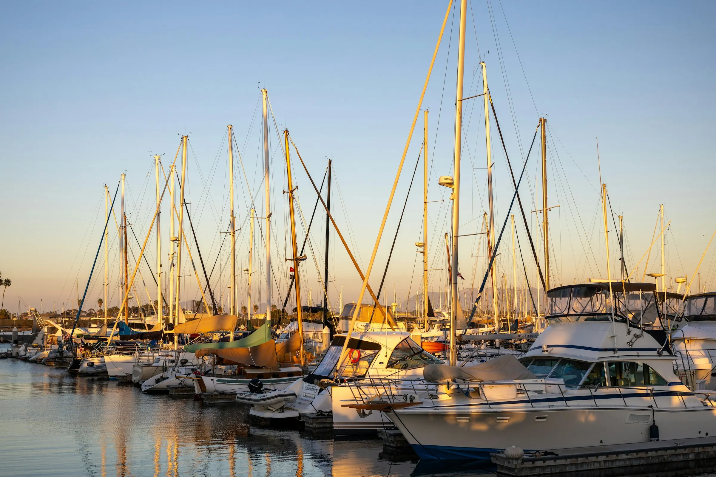 Yachts at their slips in a marina at golden hour